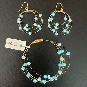 Matching gold hoop earrings and bracelet with blue pearls